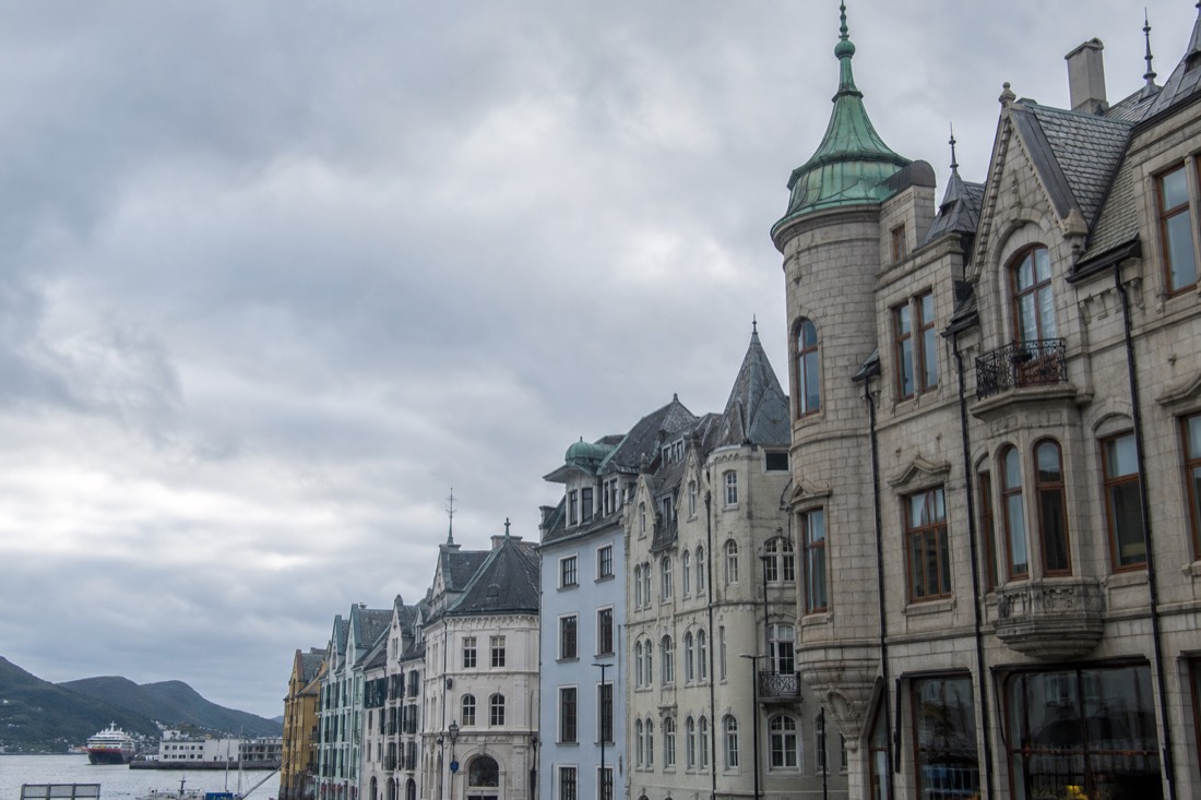 Ornate turrets and decorative stonework on early twentieth century facades above a Norwegian shopping street